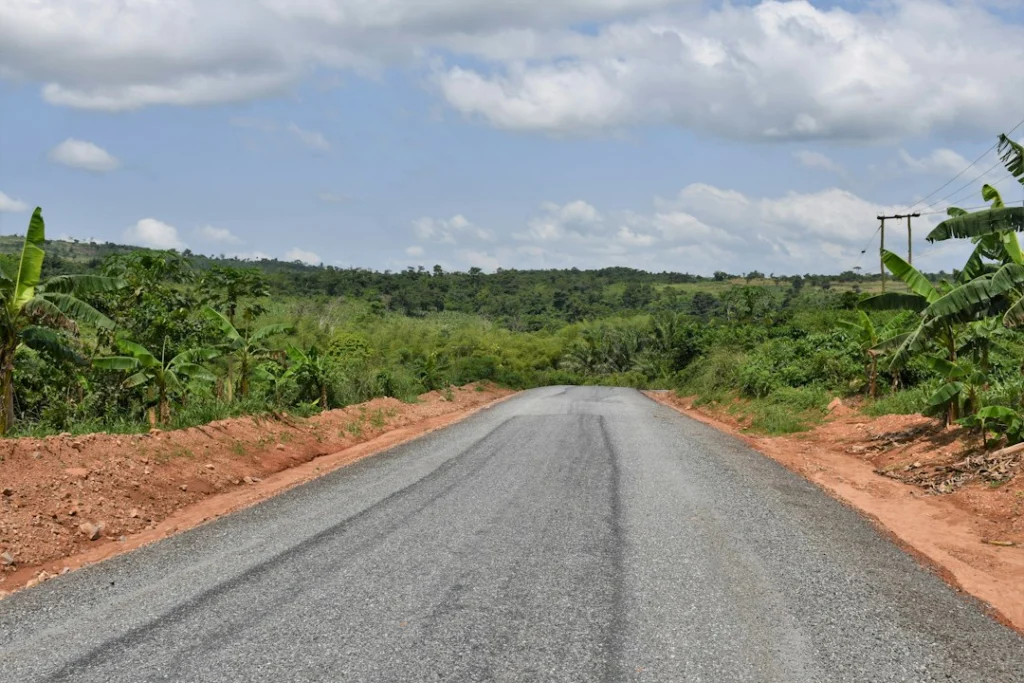 Rural road running through a green landscape, illustrative image for the Jinijini–Sampa road project report
